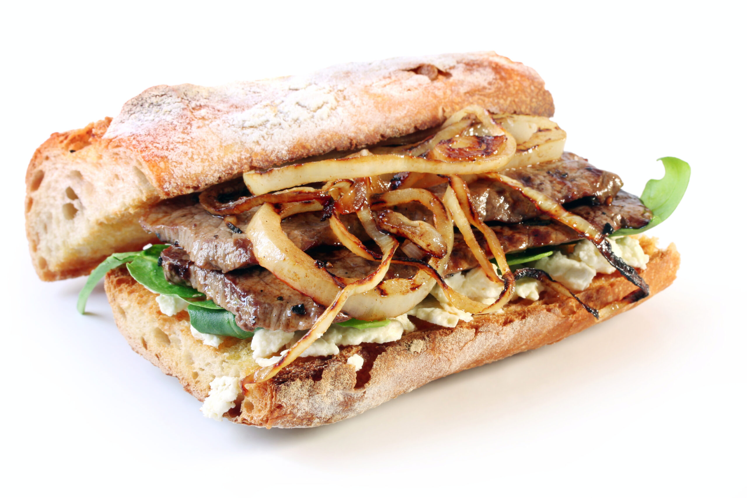 Steak sandwich.  Beef steak on a toasted baguette bread roll, with goat's cheese, spinach, and grilled onion.  Delicious!